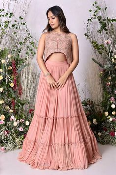 Peach attached cancan tiered lehenga. Paired with a hand embroidered blouse.
Components: 2
Pattern: Hand Embroidery
Type Of Work: Floral
Neckline: Round Neck
Sleeve Type: Sleeveless
Fabric: Viscose Georgette 
Color: Peach
Other Details: 
Attached inner lining
Lehenga:
Length: 44.5 inches
Weight: 5 kgs
Attached cancan
Blouse:
Length: 14.5 and 17 inches
Asymmetric hemline
Occasion: Sangeet - Aza Fashions Tiered Lehenga, Lehenga With Blouse, Hand Embroidered Blouse, Embroidery Floral, Blouse For Women, Blouse Online, Blouse Length, Embroidered Blouse, Aza Fashion