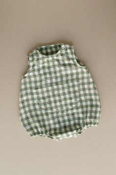 Product photos - green gingham. The model is wearing a romper in yellow gingham. Made from 100% linen, Lucy baby romper is designed to feel light and comfortable. No matter how much your little one wiggles throughout the day, the romper will stay in place thanks to elasticized cuffs on the legs and popper snap fastenings that make changing effortless. Featuring a cute chest pocket in the middle to complete a cheerful look. For any occasion or any big adventure. This baby romper is designed to be comfortably loose-fitting and allow for growth as the baby grows. Playful Green Cotton Jumpsuits And Rompers, Cute Green Cotton Jumpsuits And Rompers, Playful Summer Jumpsuits And Rompers With Pockets, Green Spring Playtime Jumpsuits And Rompers, Spring Cotton Bubble Romper With Pockets, Cute Summer Bubble Romper With Pockets, Summer Bubble Romper With Pockets For Playtime, Spring Plaid Cotton Jumpsuits And Rompers, Spring Cotton Plaid Jumpsuits And Rompers