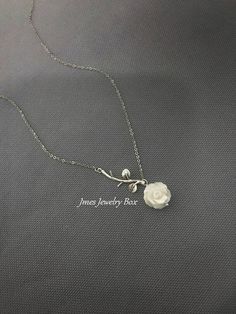 Sweet white shell rose and silver branch necklace. Very dainty but sturdy. White shell rose is double sided and 12mm wide. Silver branch and rose are on an 18'' stainless steel chain with lobster clasp. *Stainless steel chain *Silver brass branch *12mm Shell rose *Handmade with love <3 Like Jmesjewelrybox on Facebook for updates on new jewelry, upcoming sales and giveaways! Plus Facebook fans save 5% :D Find the coupon code on Jmesjewelrybox's cover photo https://www.facebook.com/Jmesjewelryb Elegant Silver Necklace With Rose Design, Silver Dainty Necklace With Rose Design, Dainty Silver Jewelry With Rose Design, Dainty Silver Necklace With Rose Design, Dainty Silver Necklaces With Rose Design, Dainty Silver Rose Design Necklaces, Silver Flower-shaped Necklace With Rose Design, Sterling Silver Rose Design Necklace For Weddings, White Flower-shaped Sterling Silver Necklace