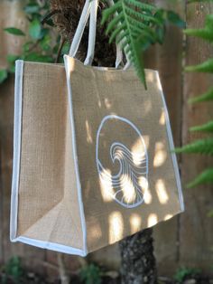 Large jute tote bag with hand painted wave design in white and natural woven handles and edge detailing. Small velcro patch to keep it closed. Perfect beach tote, for grocery shopping, or day trips. Eco-friendly Cream Beach Bag, White Jute Beach Bag For Everyday Use, White Jute Beach Bag For Daily Use, White Jute Bags For Daily Use, White Jute Beach Bag For Travel, Eco-friendly White Beach Bag Gift, Travel White Jute Beach Bag, White Rectangular Jute Beach Bag, Eco-friendly White Tote Beach Bag