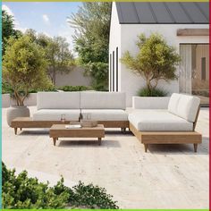 an outdoor living room with white couches and coffee table