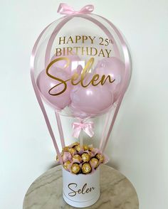 a birthday balloon and some chocolates on a table