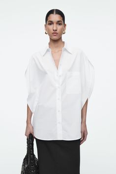 This season, the womenswear team embrace a fresh perspective on the classic cotton shirt. This white version is defined by a circle-cut silhouette that softens the lines of traditional tailoring – note the curved shoulders and three-quarter-length sleeves. Relaxed fitButton closure Shell: 100% Cotton. Excluding trims / Machine wash Back length of size EU 36 is 76.1cm / Model wears a size EU 36 Cos Shirt, Timeless Knitwear, Striped Knitted Sweater, Fresh Perspective, Denim Shirt Dress, Wool Turtleneck, Half Zip Sweaters, Fashion Design Clothes, White Shirts