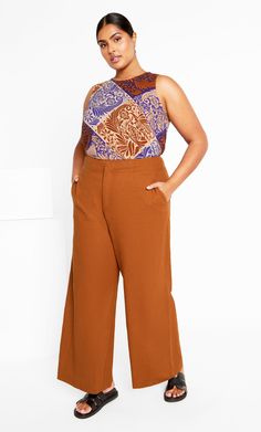 Dazzle them away with the Nala Pant. Flaunting back pockets for a sleek style and a wide-leg relaxed silhouette for maximum comfort, you will have all the style you need to conquer the fashion game. Key Features Include: - Hook and eye with front zip closure - Back pockets - Pull on style - Wide leg relaxed silhouette - Full length Coordinate with a midi skirt, sling-backs, and a sleek bun for a complete look. | Plus Size Pant Nala 24 in Ginger, Size 18/M | City Chic | Plus Size Pants Nala 24 in Summer Wide Leg Pants With Hip Pockets, Brown Wide Leg Pants With Welt Pockets, Fall Mid-rise Wide Leg Pants With Button Closure, Plus Size Statement Pants, Brown Wide Leg Pants With Side Pockets, Plus Size Rust Pants, Plus Size Brown Pants, Chic Plus Size, Sleek Bun