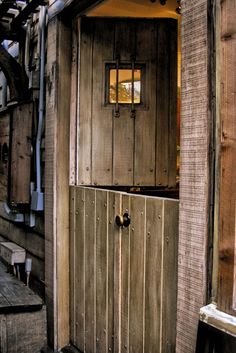 an old wooden building with a door and window