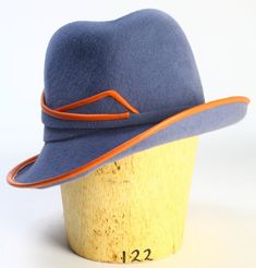 "This velour felt fedora is made by hand on a traditional milliner's hat block and then re-blocked by hand for a unique shape. Brim measures 2.5\" and crown is a glorious 4\" (can be made shorter by request). Brim and felt band is piped with Terra-cotta kidskin leather. Custom satin lining.  Made to measure. For additional felt and leather colors, please contact me. How to wear your hat: * Place hat on head with the label centered in the back * Tilt hat toward right ear  How to measure your head: (Make sure to measure your head exactly where the hat will sit)  * With a cloth measuring tape, measure the circumference of your head just above top of ears.  * Wrap tape gently and comfortably around head making certain tape lies midway on your occipital bone (that little bump in the middle of t Kate Middleton Hats, Bespoke Hats, Black Fedora Hat, Vintage Style Hat, Black Fedora, Hat Blocks, Velvet Hat, Wide Brim Fedora, Winter Hats For Men