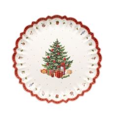 a white plate with a christmas tree and presents on the rim, decorated with red trimmings