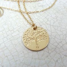 "This necklace is gorgeous and unique! A Tree of Life has been hand stamped one leaf at a time on an 20 gauge 5/8\" 14k gold fill disc. (5/8\" = approximately 16mm; slightly smaller than a nickel) Each Tree of Life will vary slightly from the picture shown--the hand stamping of the Tree of Life is an organic process and no two trees will be exactly the same. The pendant is paired with a delicate 14k gold fill cable chain in your choice of length--up to 30\"! Great for layering! Gold fill is of b Everyday Gold Nature-inspired Jewelry, Nature-inspired Everyday Gold Jewelry, Gold Hand Stamped Spiritual Jewelry, Gold Spiritual Hand Stamped Jewelry, Everyday Nature-inspired Gold Jewelry, Spiritual Gold Hand Stamped Jewelry, Minimalist Etched Gold Jewelry, Engraved Gold Nature-inspired Necklace, Nature-inspired Engraved Gold Necklace