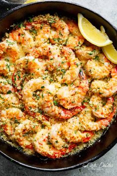 a skillet filled with cooked shrimp and garnished with parsley