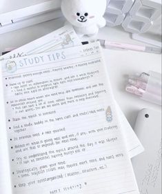 a teddy bear sitting on top of a desk next to some papers and pens with the words study tips written in it