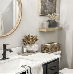 a bathroom with a sink, mirror and towel rack in it's centerpiece