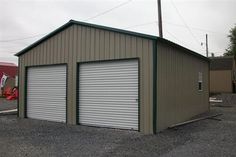 two garages with one door open and the other closed on gravel ground next to construction equipment