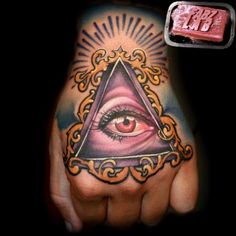 a hand with an all seeing eye tattoo on it