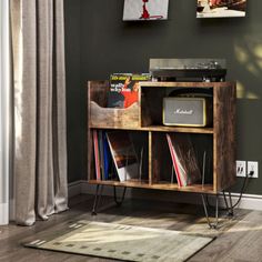 an old record player sits on top of a wooden shelf