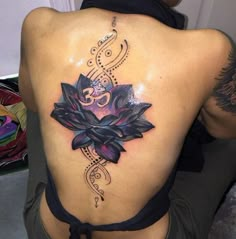 a woman with a lotus tattoo on her back