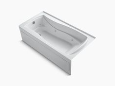 a white bath tub sitting on top of a white floor next to a wall mounted faucet