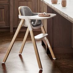 a baby high chair in a kitchen next to a counter