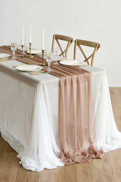 the table is set with white and orange linens