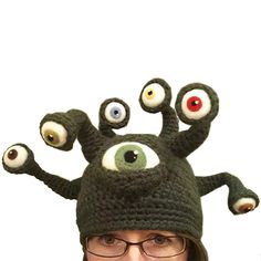 a woman wearing a knitted hat with eyeballs on it