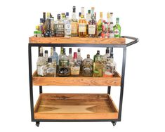 a wooden bar cart filled with liquor bottles