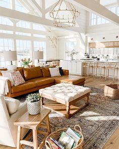 a living room filled with furniture and lots of windows