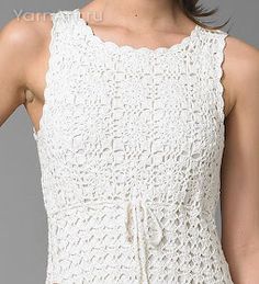 a woman wearing a white crochet dress