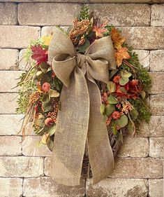 a wreath is hanging on a brick wall