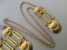 "Jakob Bengel brass watch fobs re-imagined and re-designed as rectangular pendant and screw back earrings. Great looking jewelry set. It would fall into the chunky category. Moderately heavy but very large pieces. Quite Avant Garde, Art Deco, Machine Age, Modernist. Created in the 30's and repurposed later. 1930s Necklace 24\" long 25.2 gram wt. (for pendant and necklace) Pendant: 3 1/4\" x 1\" Earrings: 3 1/4\" drop x 1\" W 17.9 gram wt (each earring) Attention: All items are listed to the best Antique Bronze Rectangular Jewelry, Antique Rectangular Bronze Jewelry, Formal Rectangular Brass Jewelry, Vintage Brass Rectangular Jewelry, Antique Rectangular Brass Jewelry, Vintage Rectangular Brass Jewelry, Gold-tone Brass Rectangular Jewelry, Rectangular Brass Jewelry In Gold-tone, Art Deco Brass Pendant Jewelry