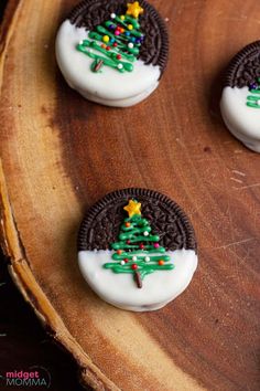 cookies decorated with christmas trees on top of a wooden board