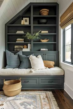 a room with some bookshelves and pillows on the bench in front of it