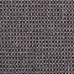 an upholstered blue and brown fabric textured with small, tiny squares in varying sizes