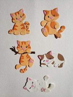 several cutouts of cats and dogs on a white surface