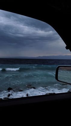 the view from inside a car looking out at the ocean