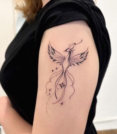 a woman with a bird tattoo on her arm