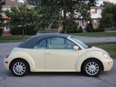 a small white car parked in a parking lot