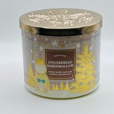 a candle that is sitting in front of a white background with snowflakes on it