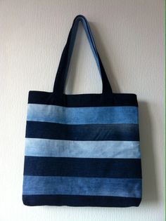 a blue and black striped bag hanging on the wall