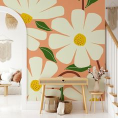 a living room with flowers painted on the wall and wooden table in front of it