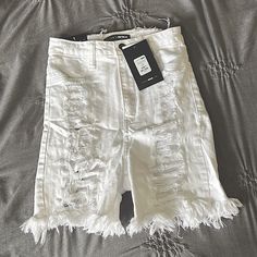 Size 1 White Fashion Nova Distressed Shorts. They Run True To Size And Are Super Stretchy! They Are High Waisted And Come Down About Mid Thigh Length. Only Tried One, Never Worn Out. Tags Still On Them. They Have Rips On Both The Front And Back Of The Shorts, With That Being Said The Back Tears Shows Some Skin. High Waist Ripped White Bottoms, Stretch Distressed White Bottoms, White High Waist Ripped Bottoms, High-waisted White Ripped Bottoms, White Distressed High Waist Bottoms, White High-waisted Ripped Bottoms, White Ripped Bottoms For Spring, Fitted Distressed White Bottoms, White Knee-length Jean Shorts For Summer