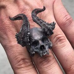 This awesome horned demon skull ring is made of solid 316L surgical stainless steel. The demon skull ring has a unique dark antiqued satin finish and approximately measures 40mm wide/long at the front center down to 8mm wide at the back of the band. This horned demon skull ring is available in sizes 8, 9, 10, 11, 12, and 13. A gift box is included with the purchase. SKU: FFJ-SSR-589 Black Skull Ring, Horn Ring, Mens Stainless Steel Rings, Biker Rings, Vintage Skull, Gothic Rings, Punk Jewelry, Black Skulls, Rings Cool