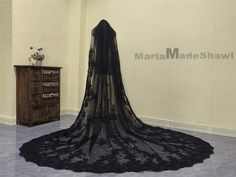 a black veil is on display in a room