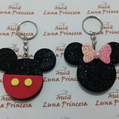 two mickey mouse keychains with bows on them