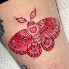 a tattoo with a red butterfly on it's thigh and hearts in the shape of a heart