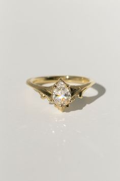 a yellow gold ring with a diamond in the center