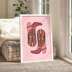 a pink poster with the letter u on it in front of a couch and window