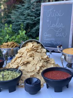 a table with chips, salsa and guacamole