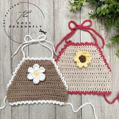 two crocheted bags sitting on top of a wooden table next to each other