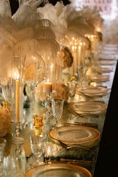 a long table with candles and plates on it