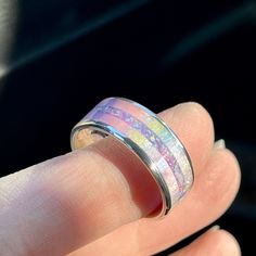 "This is a new style of my flagship Unicorn Poop ring, inlaid within a channeled band. It is carefully measured and shaped to fit within the channel perfectly, then an additional inlay of opals is crafted into the center of the channel. If you need a size that is not listed please message me for availability. Some sizes are not available for all bands. This ring may also be created in 4mm and 6mm widths. Please message me for band options in these widths! I cannot replicate rings to match any ph Luxury Iridescent Rings For Wedding, Luxury Iridescent Wedding Rings, Luxury Iridescent Opal Ring As Gift, Pastel Rings, Pastel Ring, Channel Ring, Unicorn Ring, Unicorn Poop, Opal Band