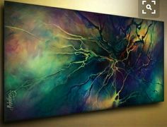 an abstract painting is hanging on the wall